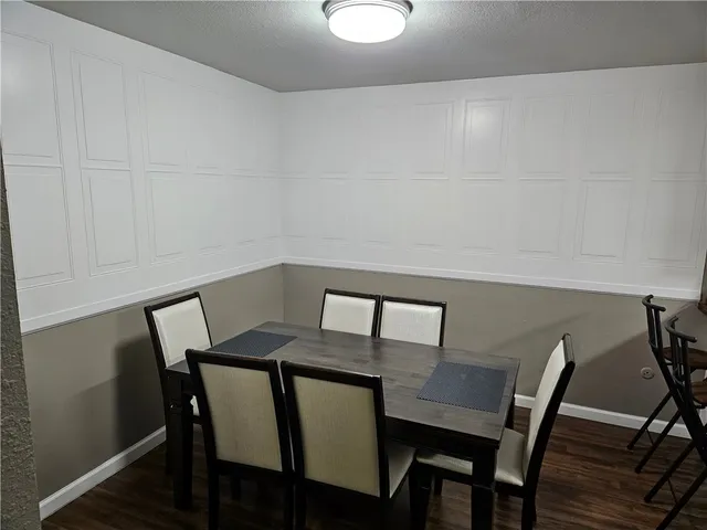 a view of a room with furniture and wooden floor