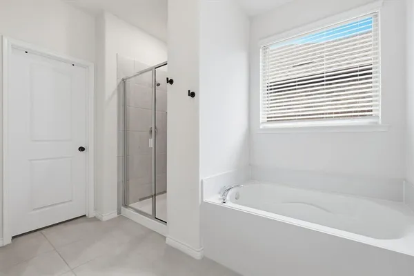 a spacious bathroom with a double vanity sink a mirror and a shower