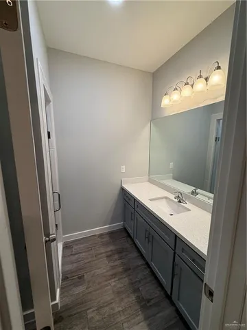 en empty room with wooden floor and ceiling fan