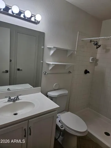 a swimming pool that has lawn chairs and a dining table under an umbrella