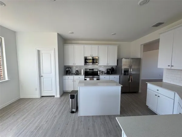 a kitchen with a sink stove and refrigerator