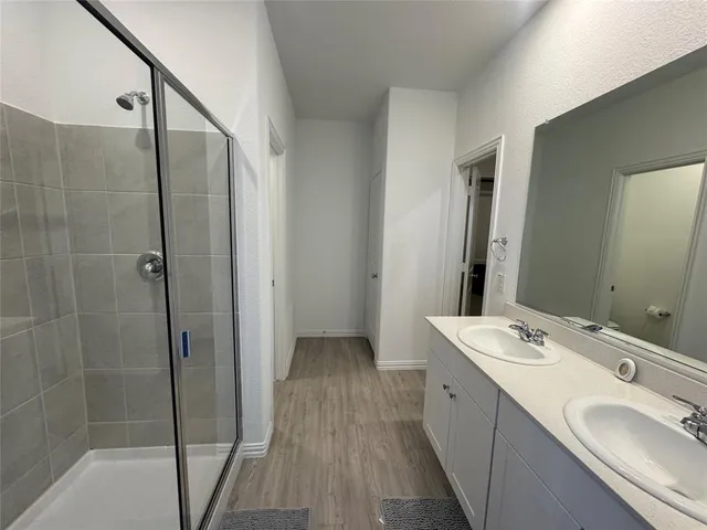 a bathroom with a double vanity sink and mirror