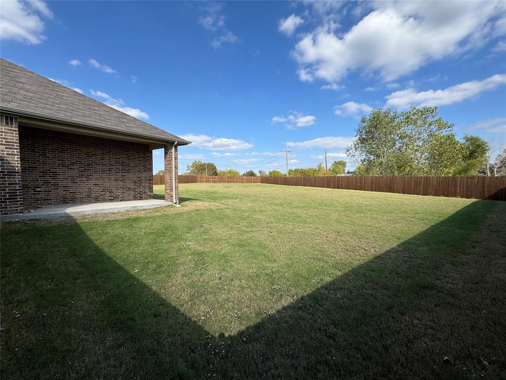 4905 Sagerun Drive Princeton, TX 75407 - Photo 23 of 25 a backyard of a house with lots of green space and outdoor seating