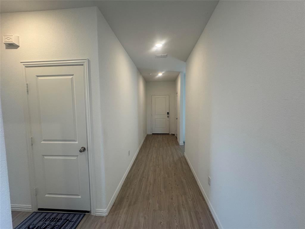 4905 Sagerun Drive Princeton, TX 75407 - Photo 3 of 25 a view of a hallway with wooden floor
