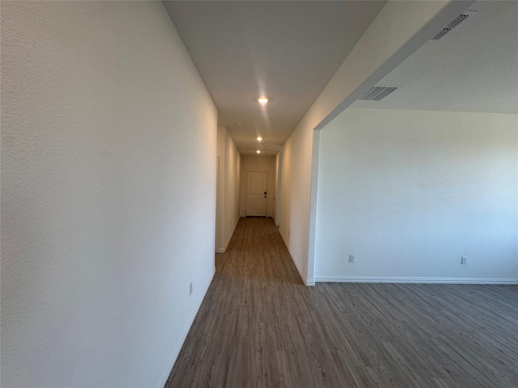 4905 Sagerun Drive Princeton, TX 75407 - Photo 4 of 25 a view of a hallway with wooden floor