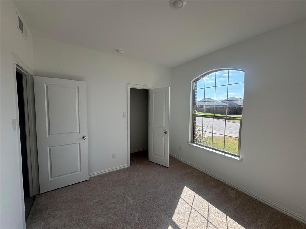 4905 Sagerun Drive Princeton, TX 75407 - Photo 6 of 25 an empty room with windows and closet