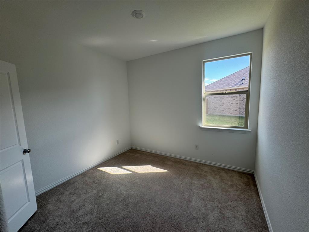 4905 Sagerun Drive Princeton, TX 75407 - Photo 8 of 25 an empty room with windows
