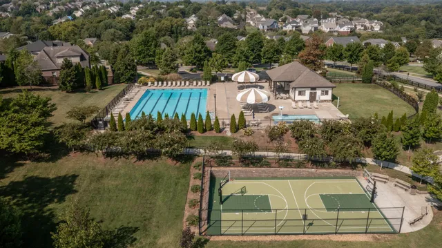 an aerial view of a house with outdoor space and lake view