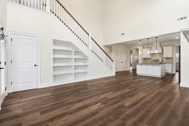 a view of a kitchen with wooden floor and electronic appliances