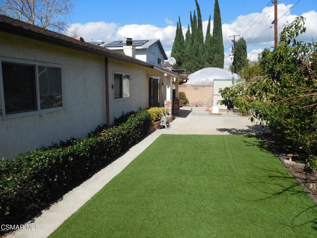 1394 Sycamore Drive Simi Valley, CA 93065 - Photo 12 of 13 a view of a backyard with plants and a patio