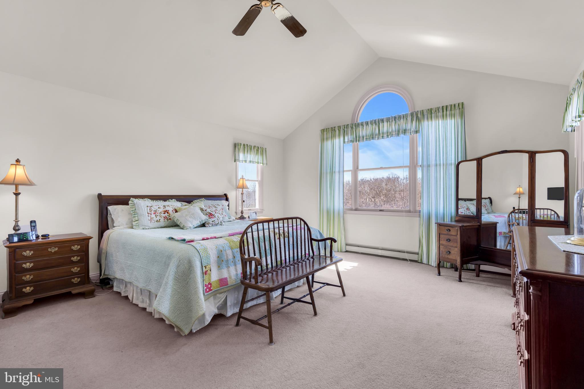 309 Pennington Harbourton Road Pennington, NJ 08534 - Photo 21 of 67 a spacious bedroom with a bed a table and large mirror with window