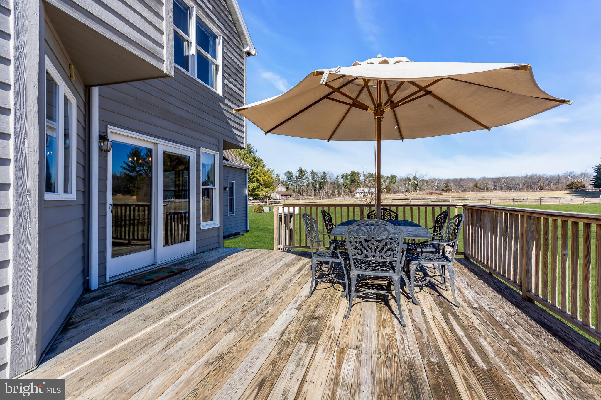 309 Pennington Harbourton Road Pennington, NJ 08534 - Photo 36 of 67 a view of a patio with a table chairs and a umbrella