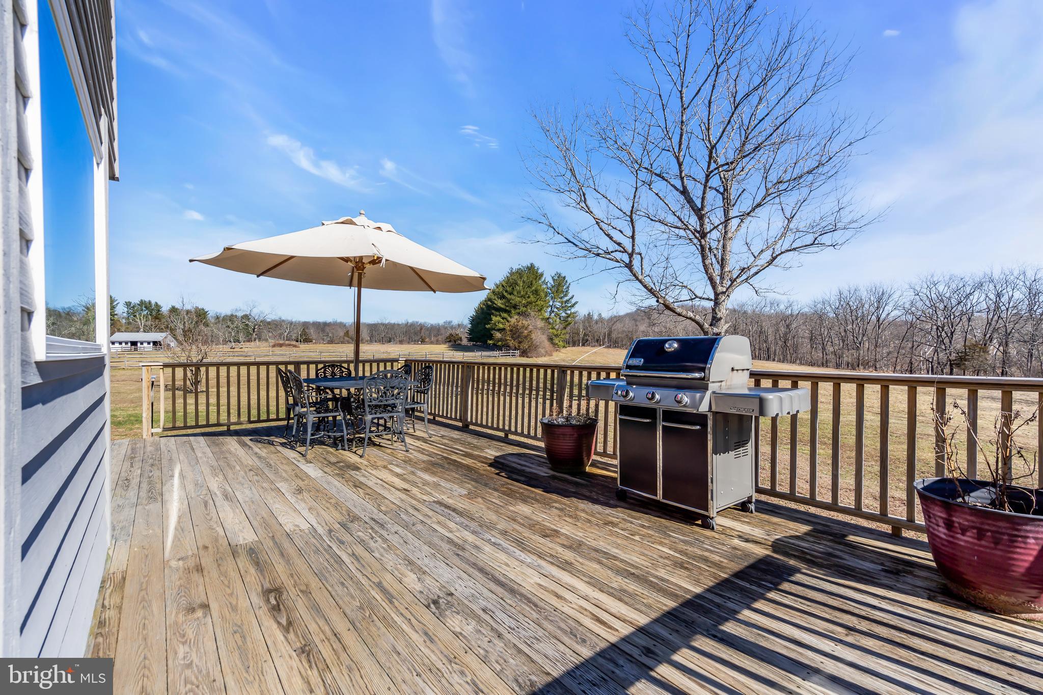 309 Pennington Harbourton Road Pennington, NJ 08534 - Photo 37 of 67 a view of a roof deck with wooden floor and fence with a barbeque grill and couches