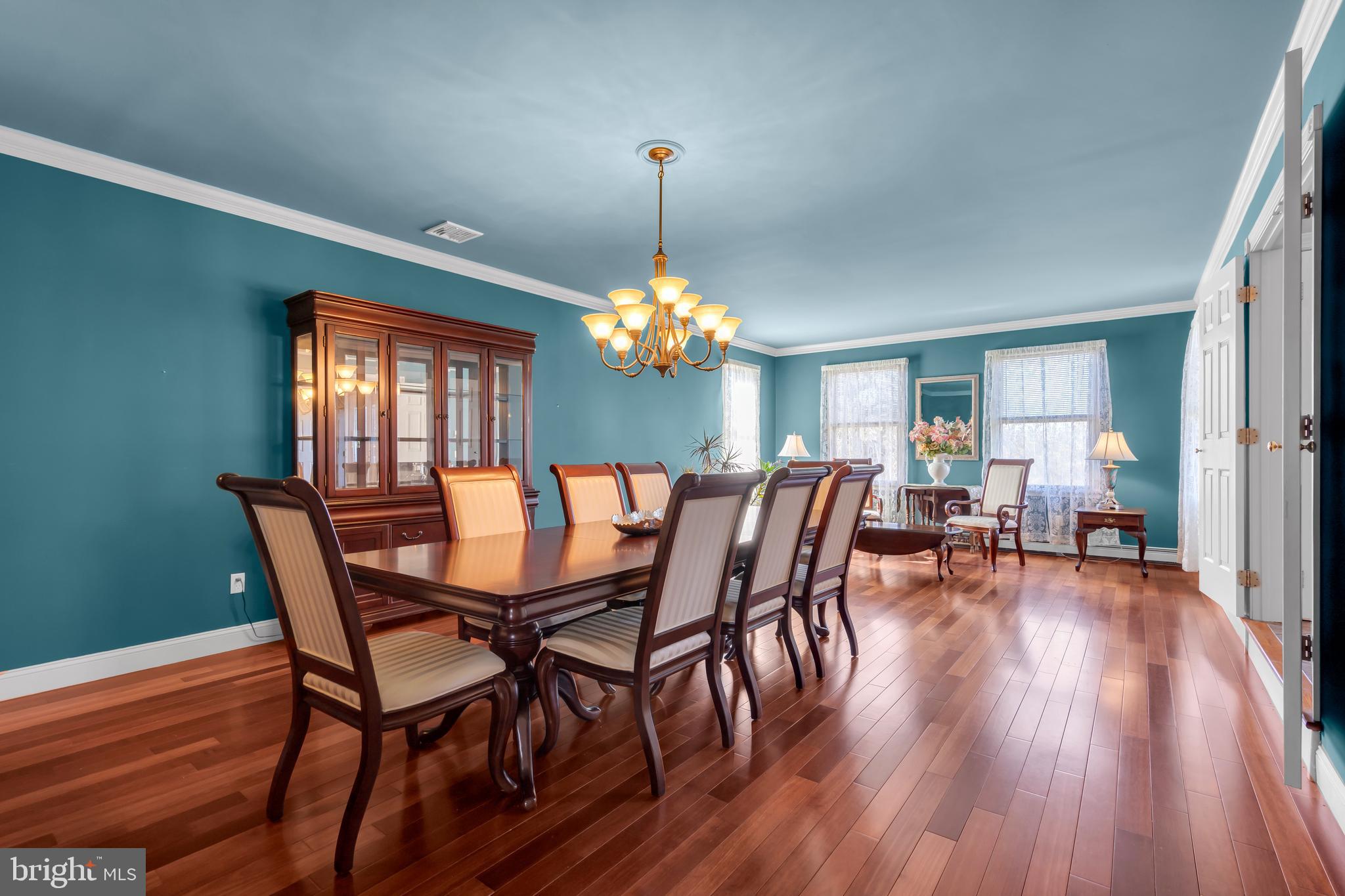 309 Pennington Harbourton Road Pennington, NJ 08534 - Photo 6 of 67 a dining room with furniture a chandelier and wooden floor