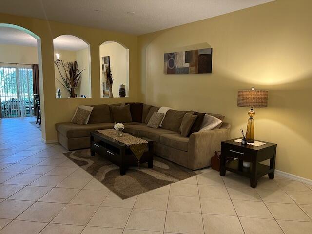 106 Lighthouse Circle, Unit G Tequesta, FL 33469 - Photo 13 of 34 a living room with couches and a flat screen tv