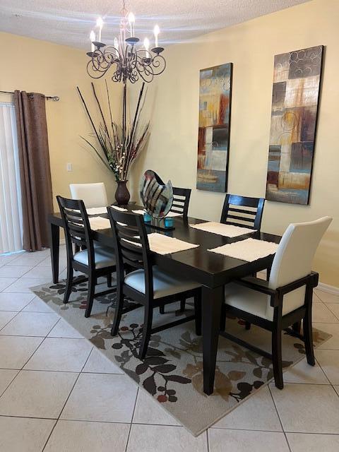 106 Lighthouse Circle, Unit G Tequesta, FL 33469 - Photo 15 of 34 a view of a dining room with furniture and chandelier