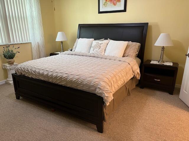 106 Lighthouse Circle, Unit G Tequesta, FL 33469 - Photo 21 of 34 a large bed sitting in a bedroom next to a lamp