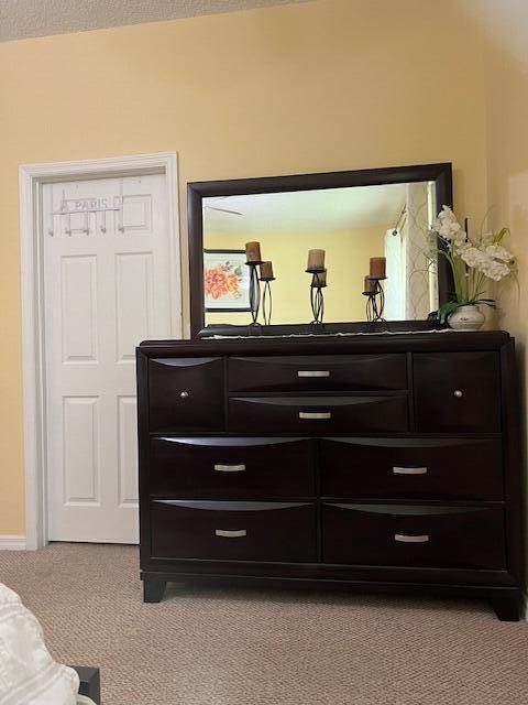 106 Lighthouse Circle, Unit G Tequesta, FL 33469 - Photo 23 of 34 a living room with furniture and a mirror