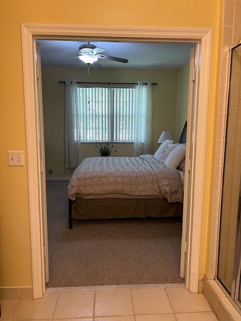 106 Lighthouse Circle, Unit G Tequesta, FL 33469 - Photo 25 of 34 a bedroom with a bed and a window