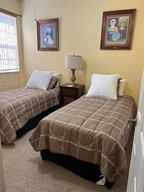 106 Lighthouse Circle, Unit G Tequesta, FL 33469 - Photo 26 of 34 a bedroom with two beds and a window