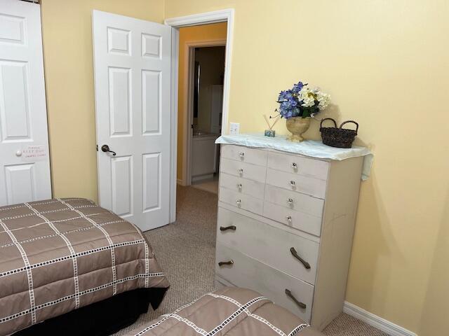 106 Lighthouse Circle, Unit G Tequesta, FL 33469 - Photo 27 of 34 a bedroom with a bed and a dresser