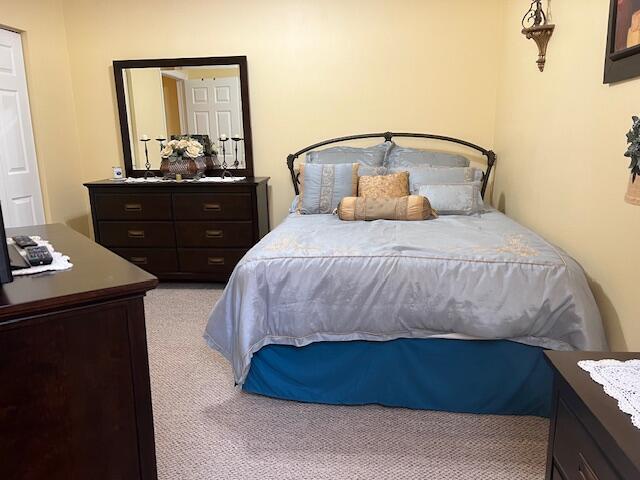 106 Lighthouse Circle, Unit G Tequesta, FL 33469 - Photo 28 of 34 a bedroom with a bed and window