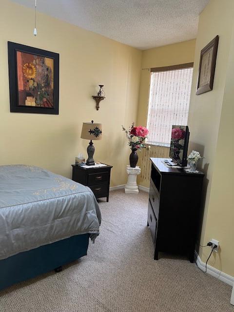 106 Lighthouse Circle, Unit G Tequesta, FL 33469 - Photo 29 of 34 a bedroom with a bed and a window