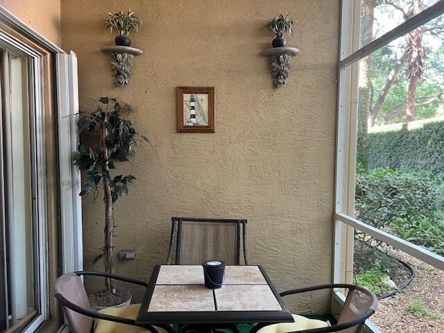 106 Lighthouse Circle, Unit G Tequesta, FL 33469 - Photo 33 of 34 a vase of flowers sitting on a table with a potted plant
