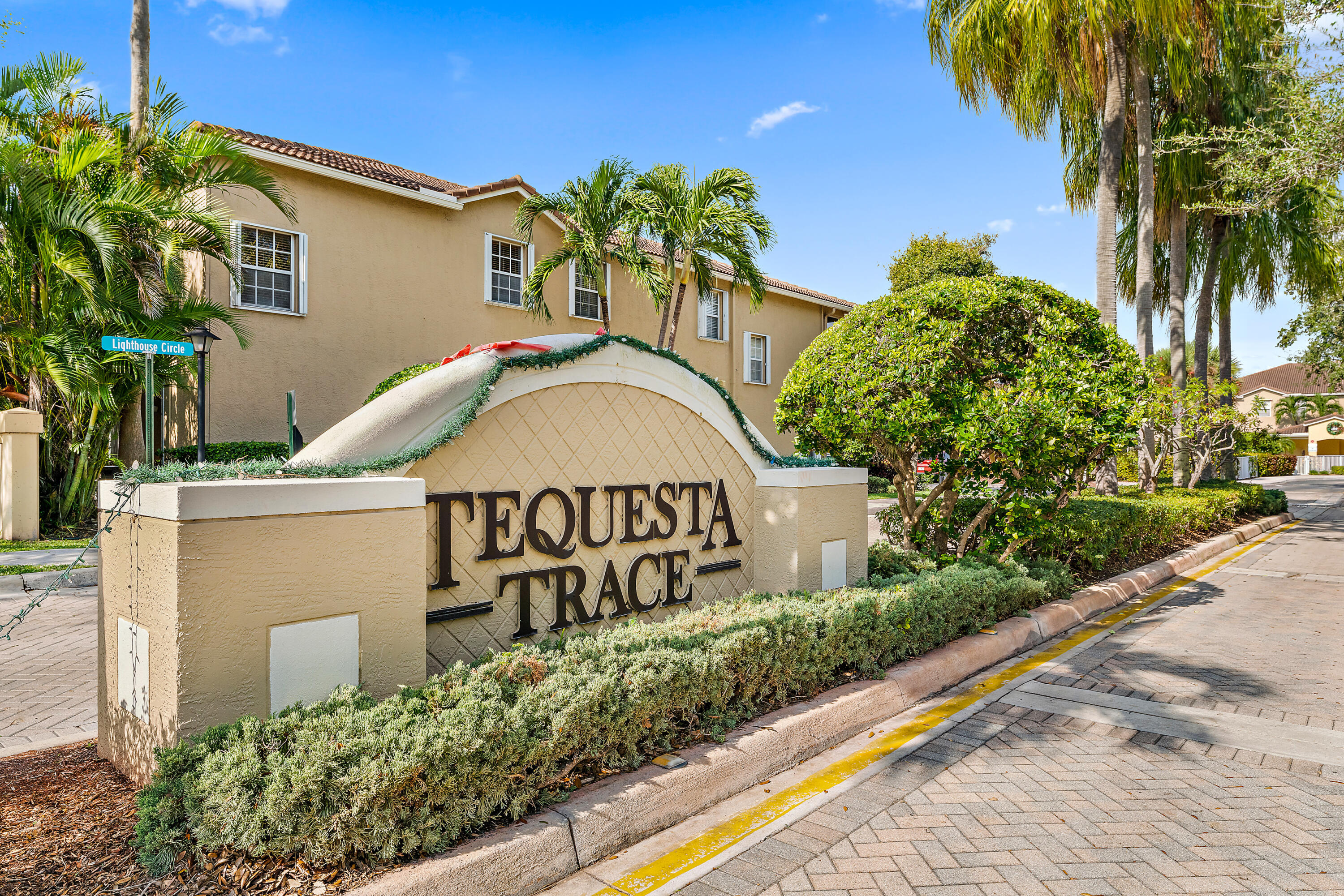 106 Lighthouse Circle, Unit G Tequesta, FL 33469 - Photo 5 of 34 a view of a house with a yard and a garage