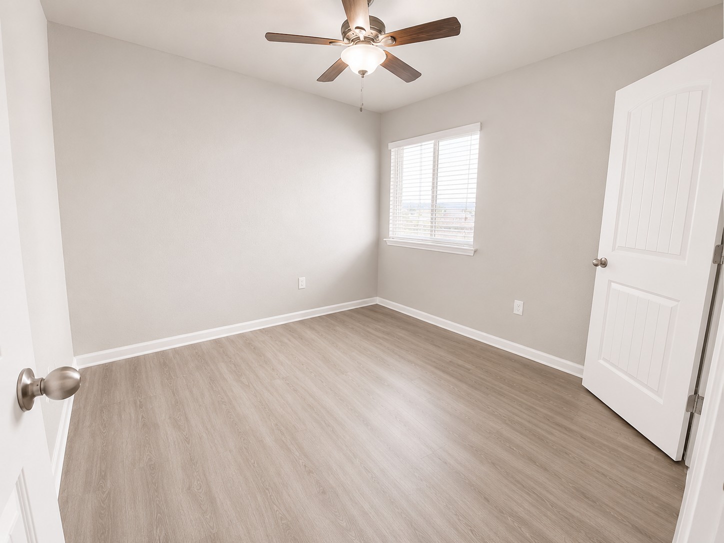 228 Avalanche Avenue Georgetown, TX 78626 - Photo 8 of 16 an empty room with wooden floor fan and windows