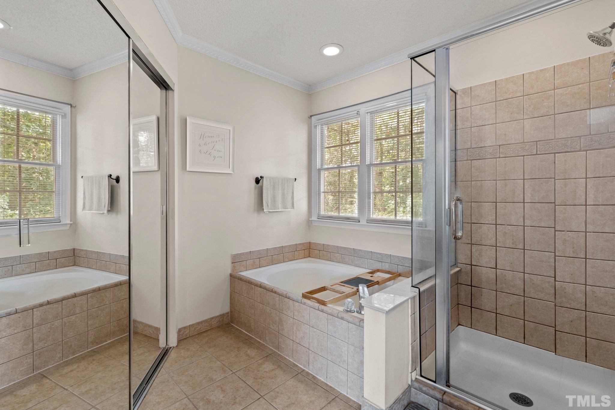 5217 Denmead Way Raleigh, NC 27613 - Photo 20 of 30 a bathroom with a tub a sink and a shower