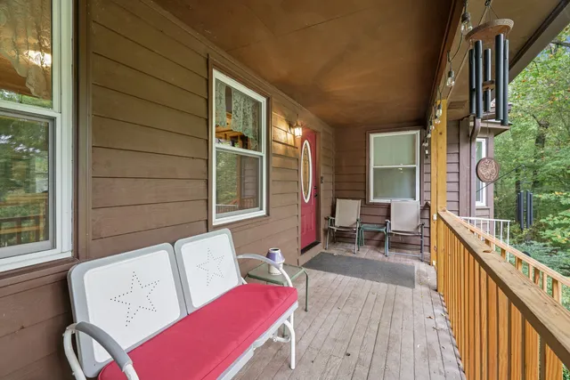 a kitchen with stainless steel appliances granite countertop a stove top oven a sink dishwasher a dining table and chairs with wooden floor