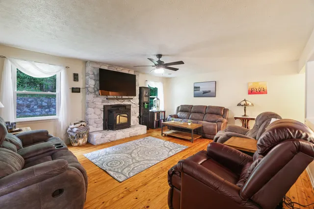 a bedroom with a bed a window and a flat screen television