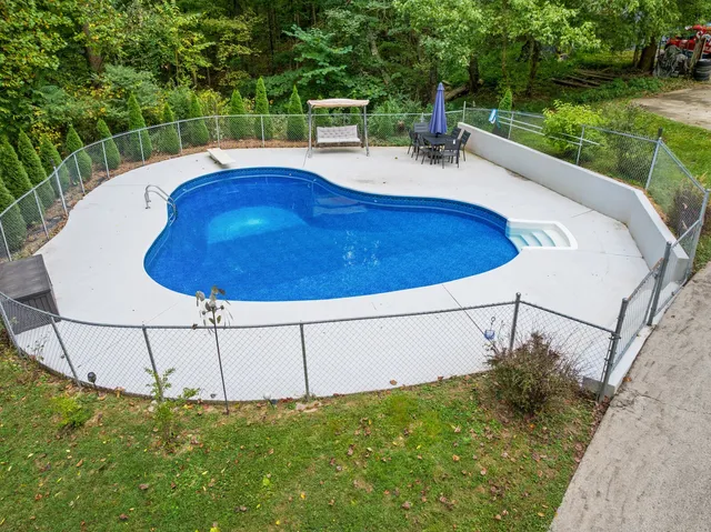 a view of a patio with a table and chairs under an umbrella