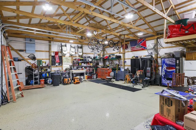 a view of a house with a yard and large tree