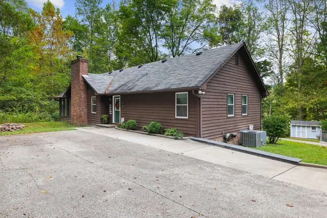 a kitchen with granite countertop a sink stainless steel appliances and white cabinets
