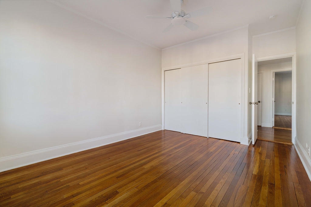 321 Tappan Street, Unit 1 Brookline, MA 02445 - Photo 13 of 19 a view of an empty room with wooden floor