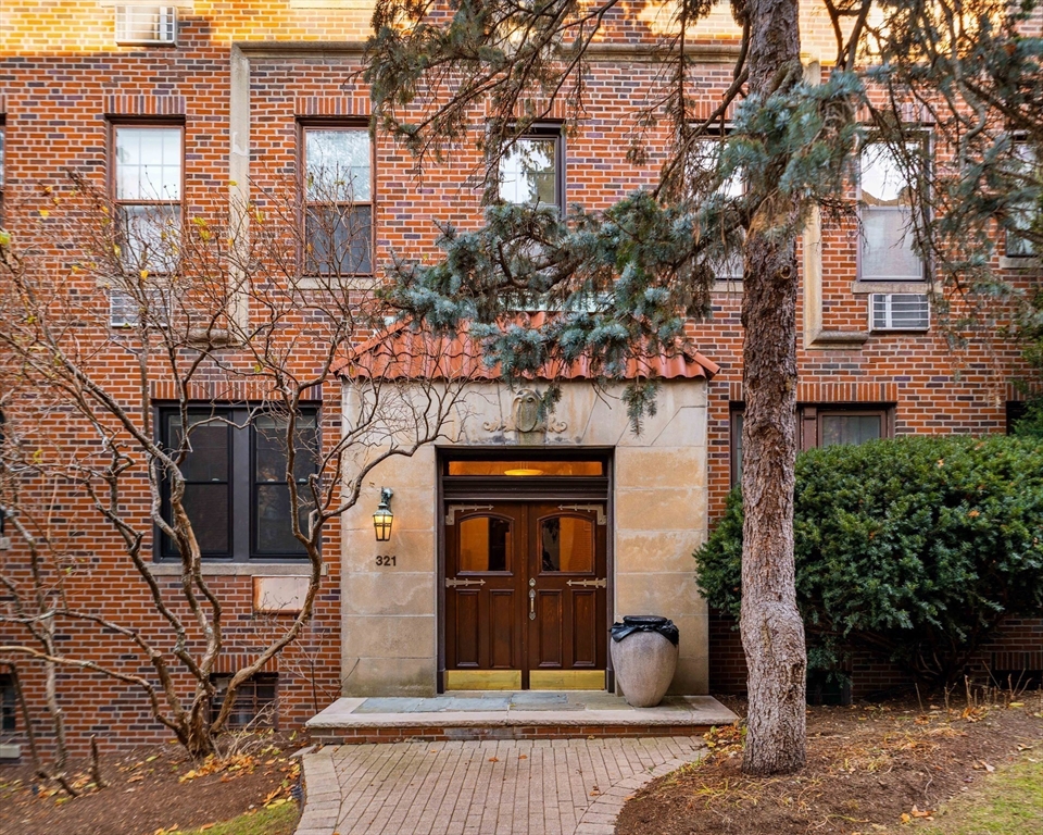 321 Tappan Street, Unit 1 Brookline, MA 02445 - Photo 19 of 19 a front view of a house with garden