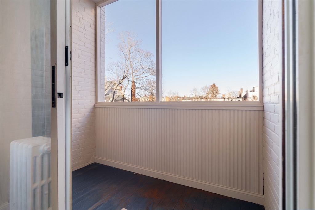 321 Tappan Street, Unit 1 Brookline, MA 02445 - Photo 9 of 19 a view of a small space with wooden floor and a window