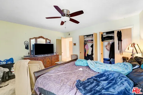 a bedroom with bed and tv