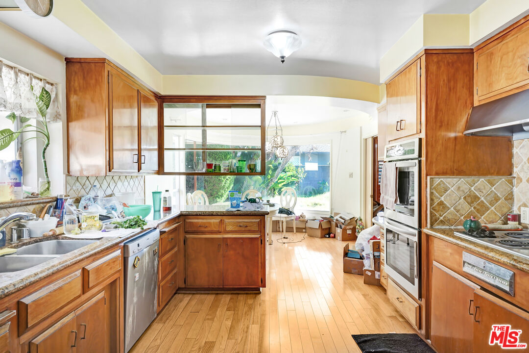6424 Shenandoah Avenue Los Angeles, CA 90056 - Photo 32 of 35 a kitchen with stainless steel appliances wooden floor and a large window