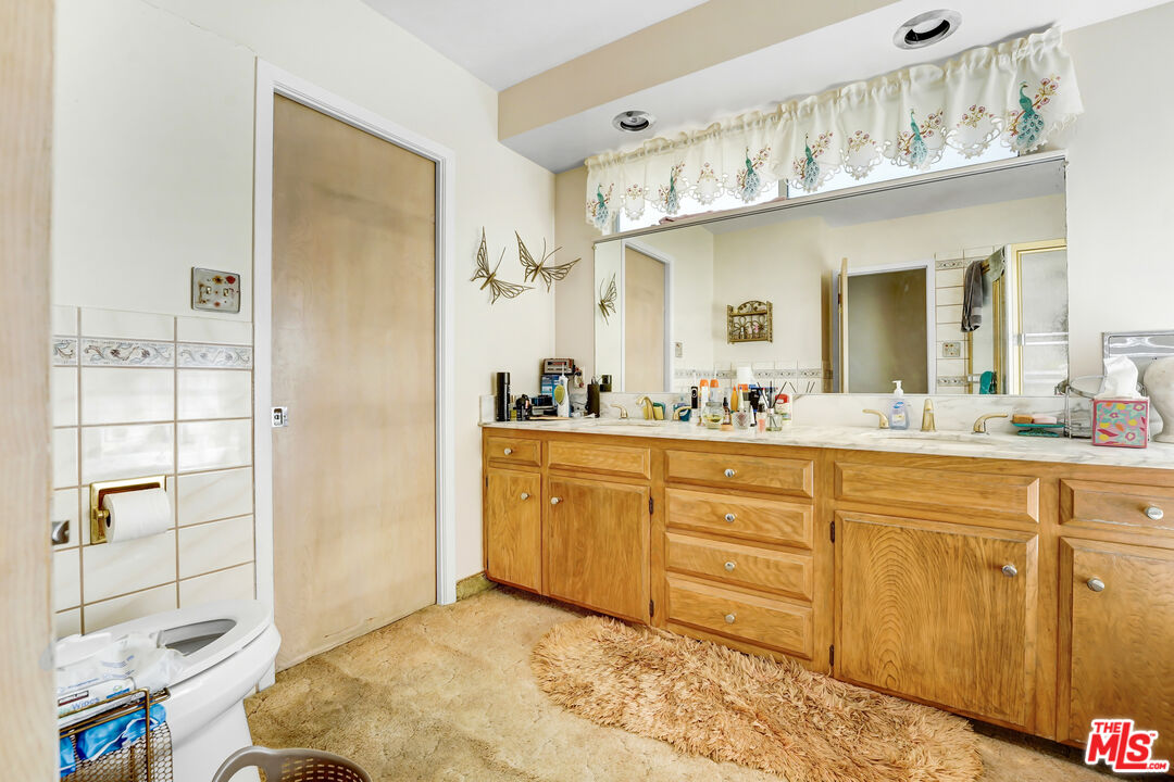 6424 Shenandoah Avenue Los Angeles, CA 90056 - Photo 9 of 35 a spacious bathroom with a sink a mirror and a shower
