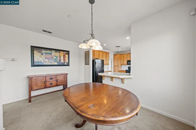 a view of a kitchen with a sink and a chandelier
