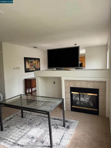 a living room with a fireplace and a flat screen tv