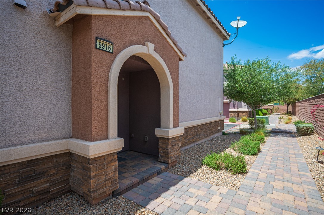 9916 Sable Point Street Las Vegas, NV 89178 - Photo 7 of 73 An inviting paver pathway leads to the front door of this charming residence, enhanced by mature landscaping.
