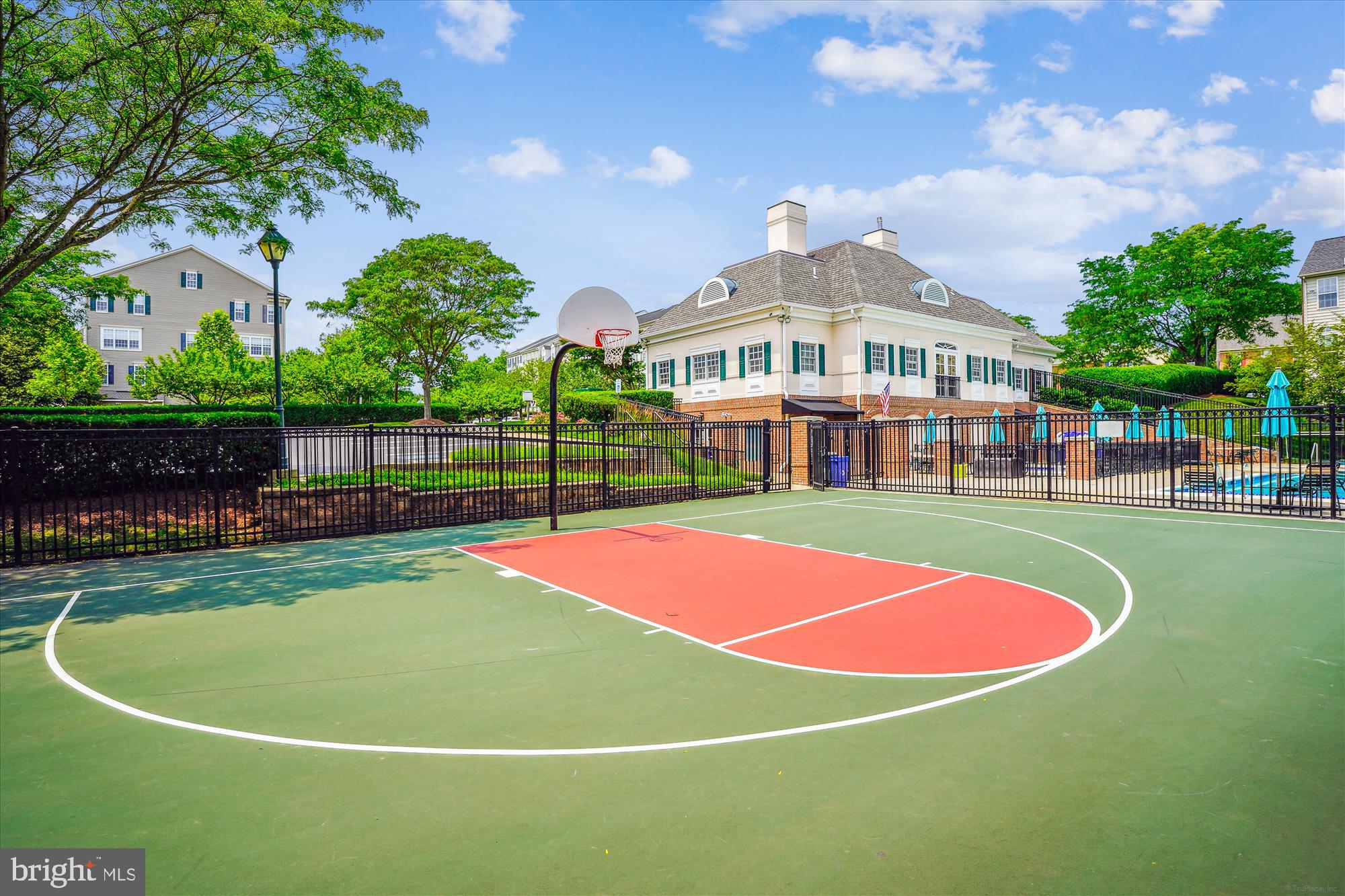 142 Swanton Lane Gaithersburg, MD 20878 - Photo 54 of 68 a view of a tennis ground with large trees in the background
