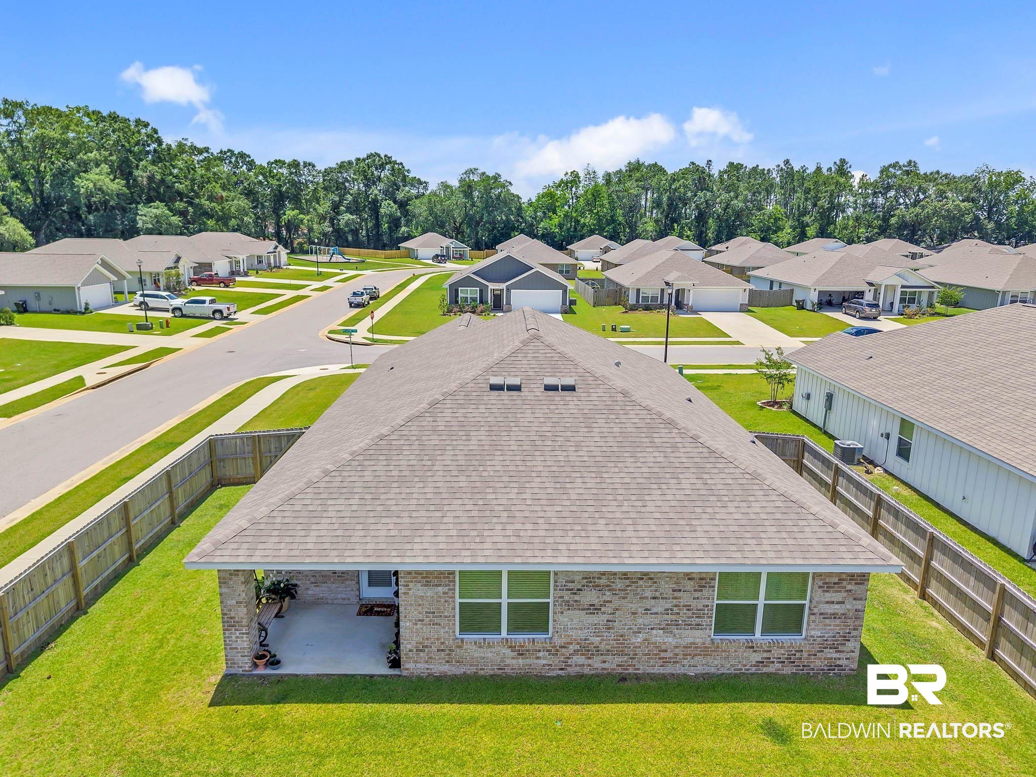 17217 REFLECTION Street Loxley, AL 36551 - Photo 64 of 83 Aerial view of residential area with a tree filled landscape