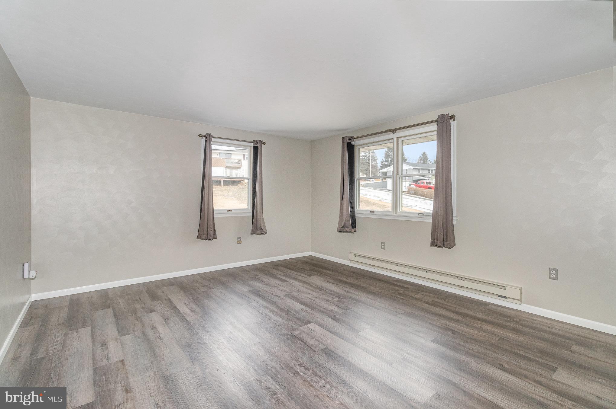 15 Penn Circle Hanover, PA 17331 - Photo 16 of 32 an empty room with wooden floor and windows
