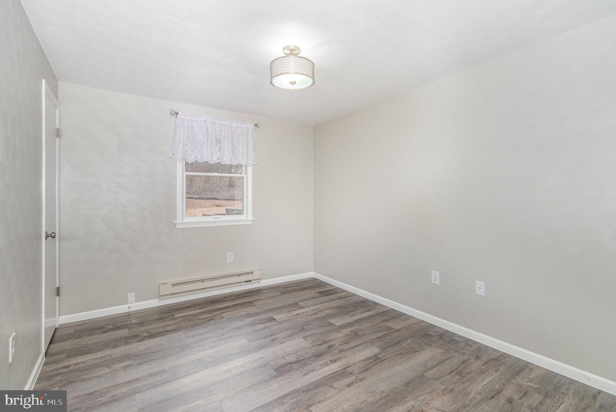 15 Penn Circle Hanover, PA 17331 - Photo 19 of 32 wooden floor in an empty room with a window
