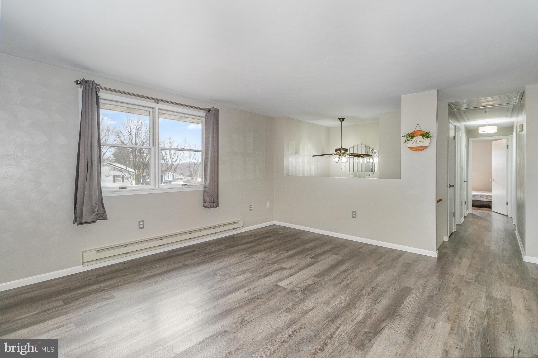 15 Penn Circle Hanover, PA 17331 - Photo 4 of 32 an empty room with wooden floor and windows